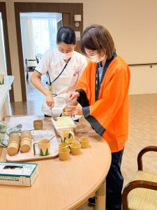スタッフと入居者が一緒に調理や食事準備をしている様子